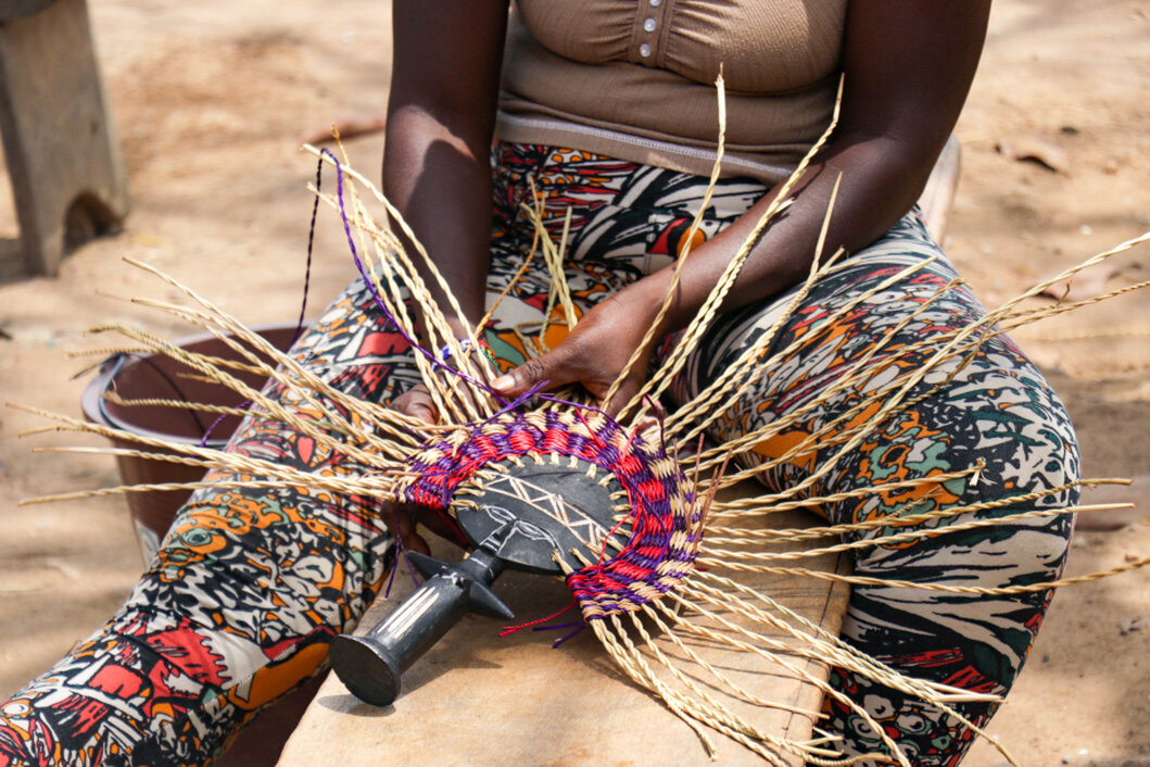 Ghanaian artisan handcrafting a product in a small workshop