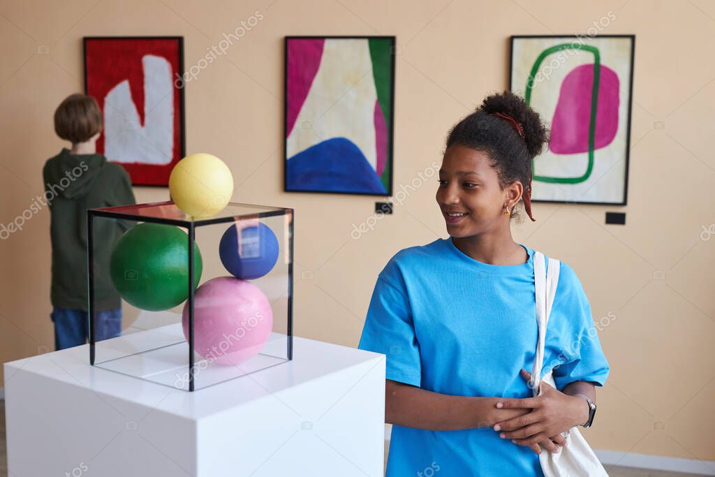Display of handcrafted African wooden sculptures and bronze masks
